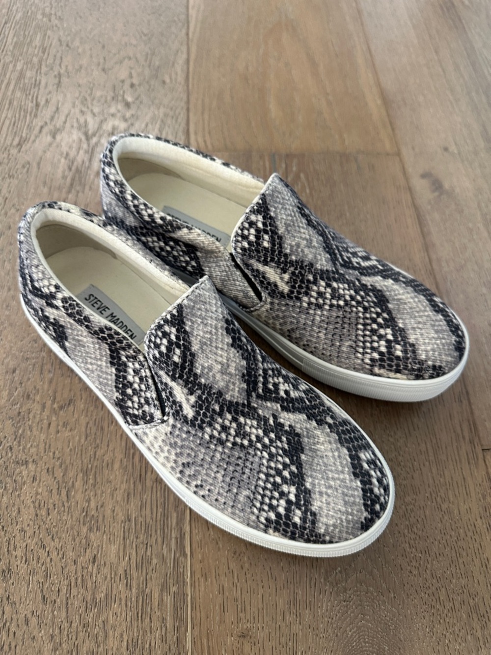 Steve Madden Women’s Snake-Print Slip-On Sneakers in Black and Cream